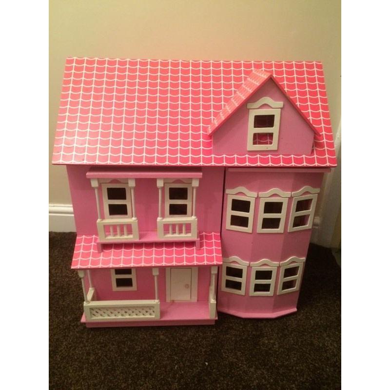 Pink wooden dolls house with furniture