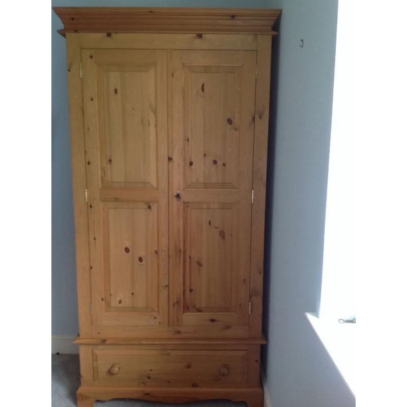Pair of solid pine wardrobes with brass fittings and deep drawer