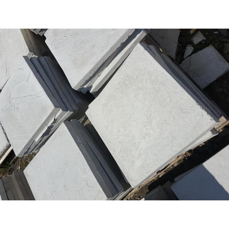 Light grey 450x450x38mm Riven concrete paving slabs.