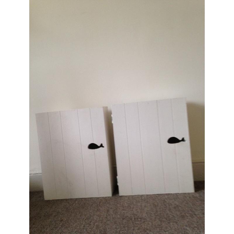Two wooden bathroom wall cabinets with whale design handles