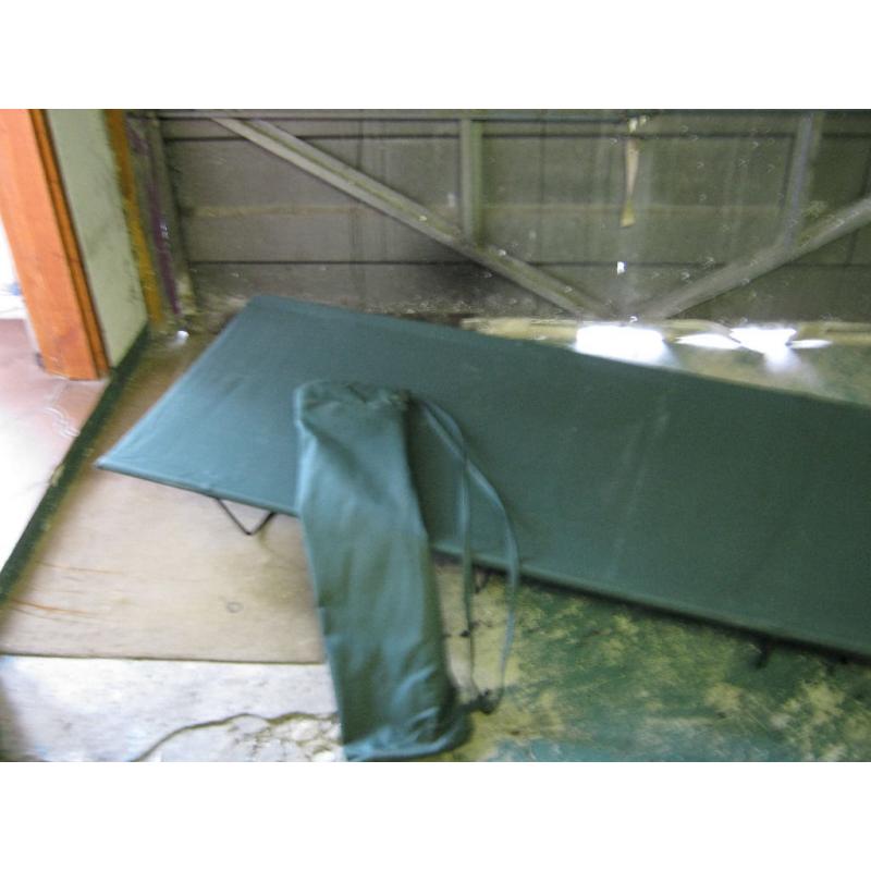 Green single person campbed